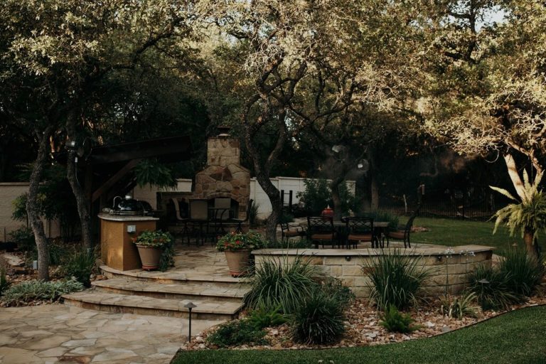 Outdoor entertaining ideas brought to life with a flagstone patio, outdoor kitchen, and fireplace by expert masonry services