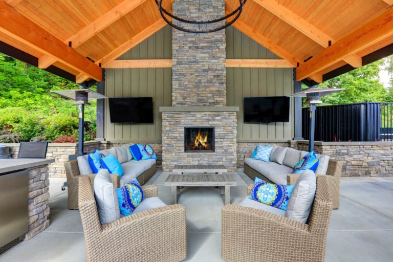 Cozy outdoor living area featuring a fireplace and seating, showcasing beautiful Hardscapes for relaxation