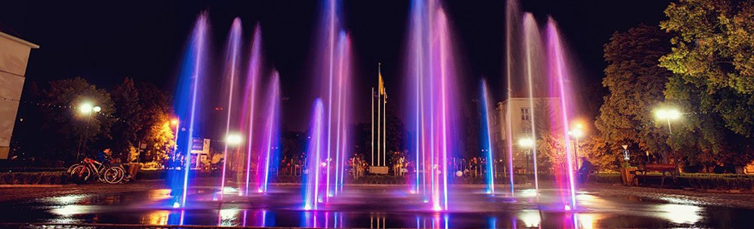 Vibrant fountain illuminated by colorful lights, creating a magical atmosphere at night