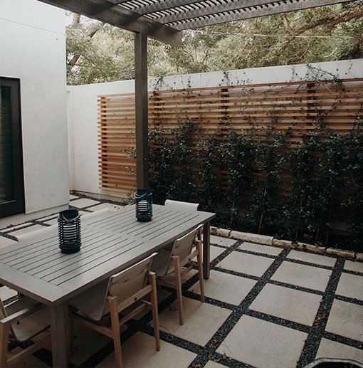 Modern outdoor dining area featuring hardscapes with a stylish table