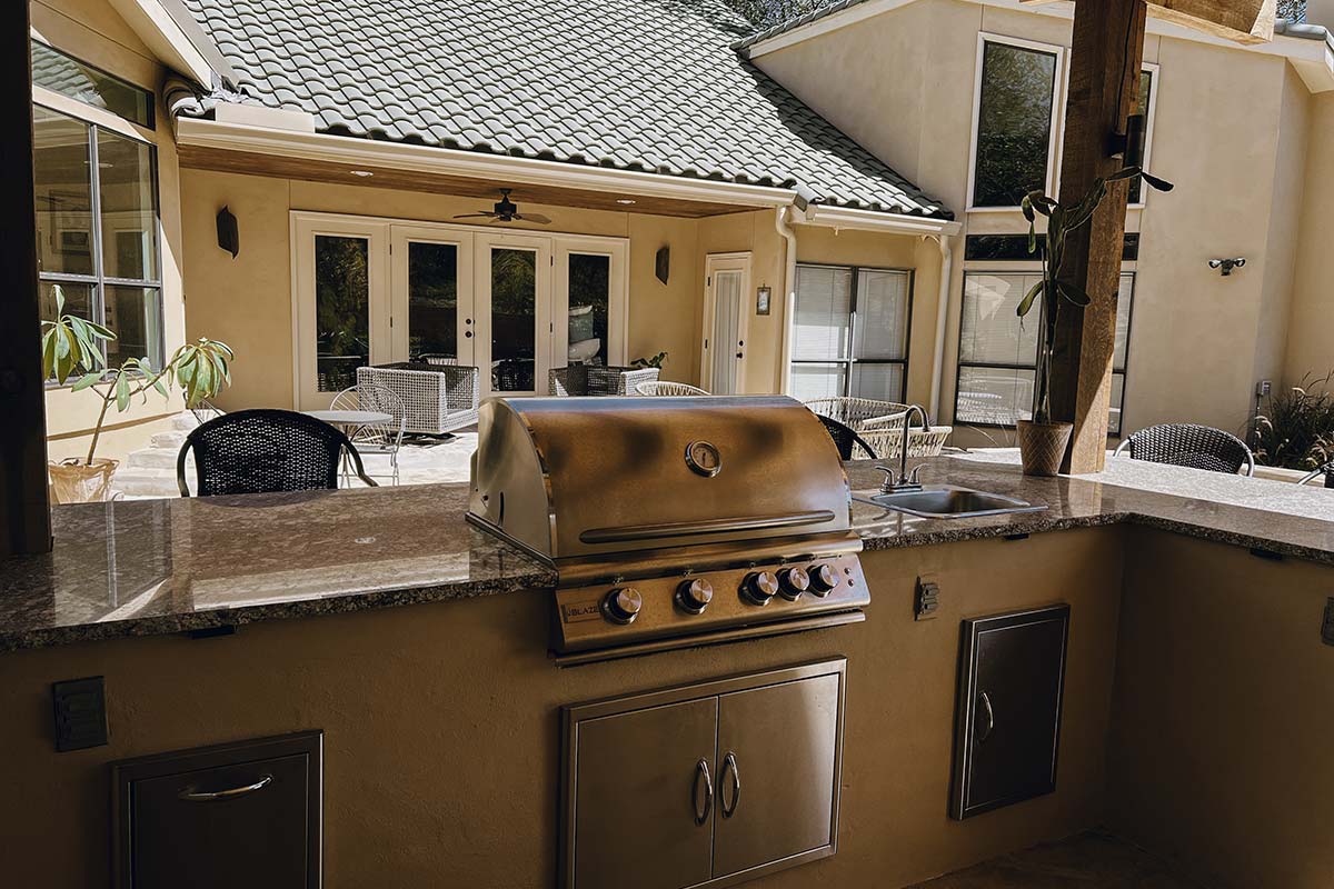 Outdoor Kitchens featuring a grill and sink, perfect for cooking and entertaining in style