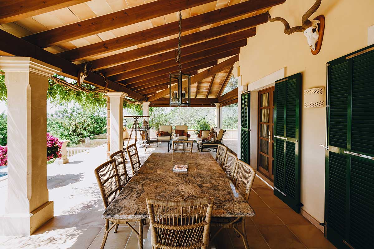 Cozy patio featuring a table and chairs, showcasing beautiful hardscapes for outdoor relaxation