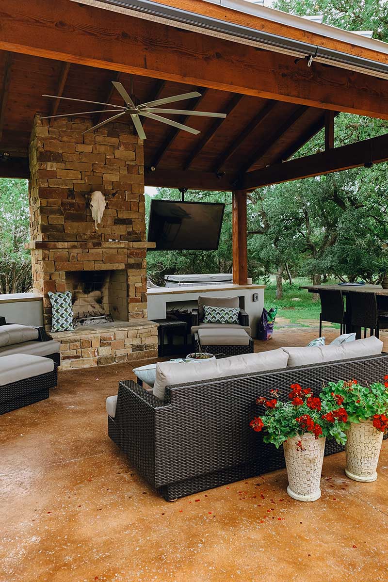 Cozy patio featuring a fireplace and couches, showcasing beautiful Hardscapes for relaxation and gatherings