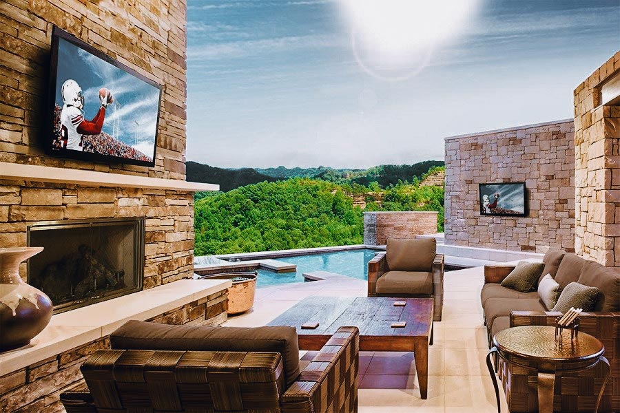 Cozy living room featuring a fireplace and television, showcasing beautiful Hardscapes design elements