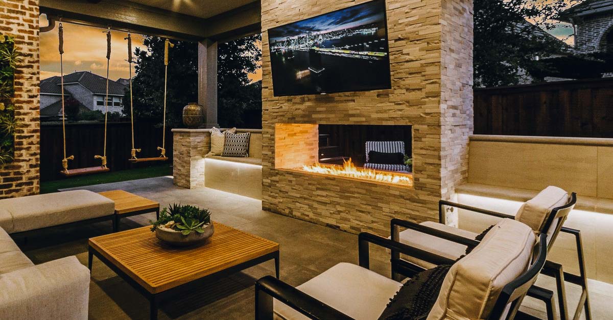 Modern outdoor living area featuring a cozy fireplace, showcasing beautiful Hardscapes for relaxation and entertainment