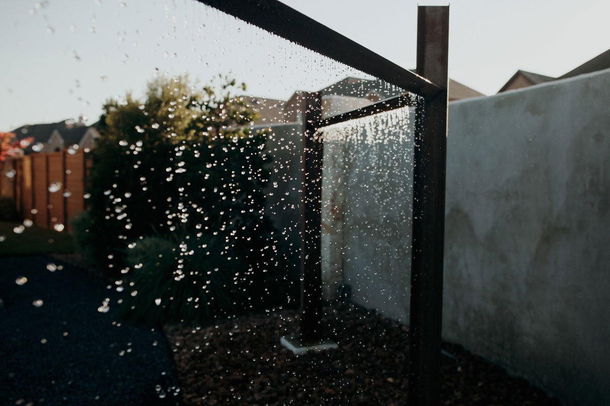 Water Features shower with water cascading down, creating a refreshing and serene atmosphere