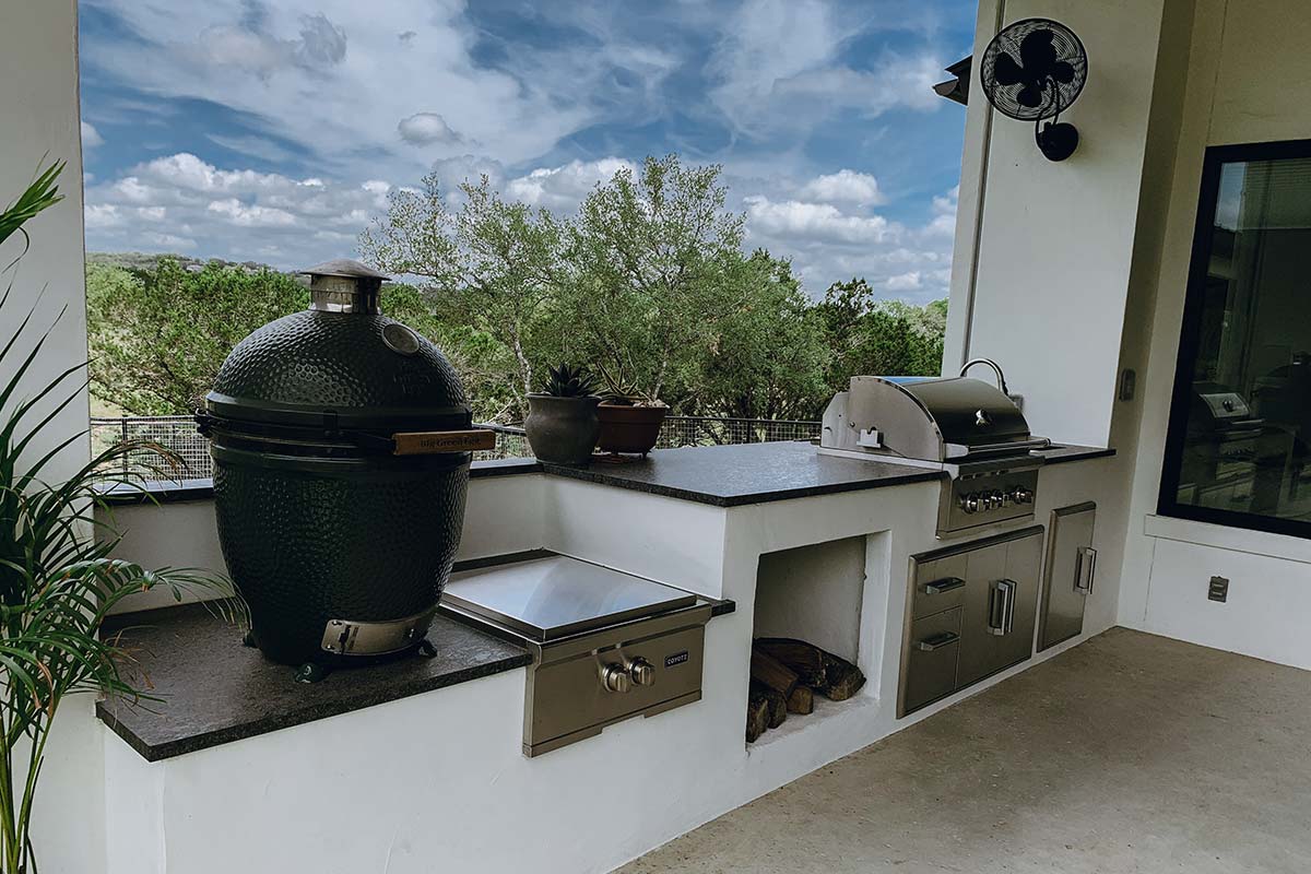 Outdoor Kitchens setup featuring a large grill and pot on a balcony, perfect for cooking and entertaining outdoors