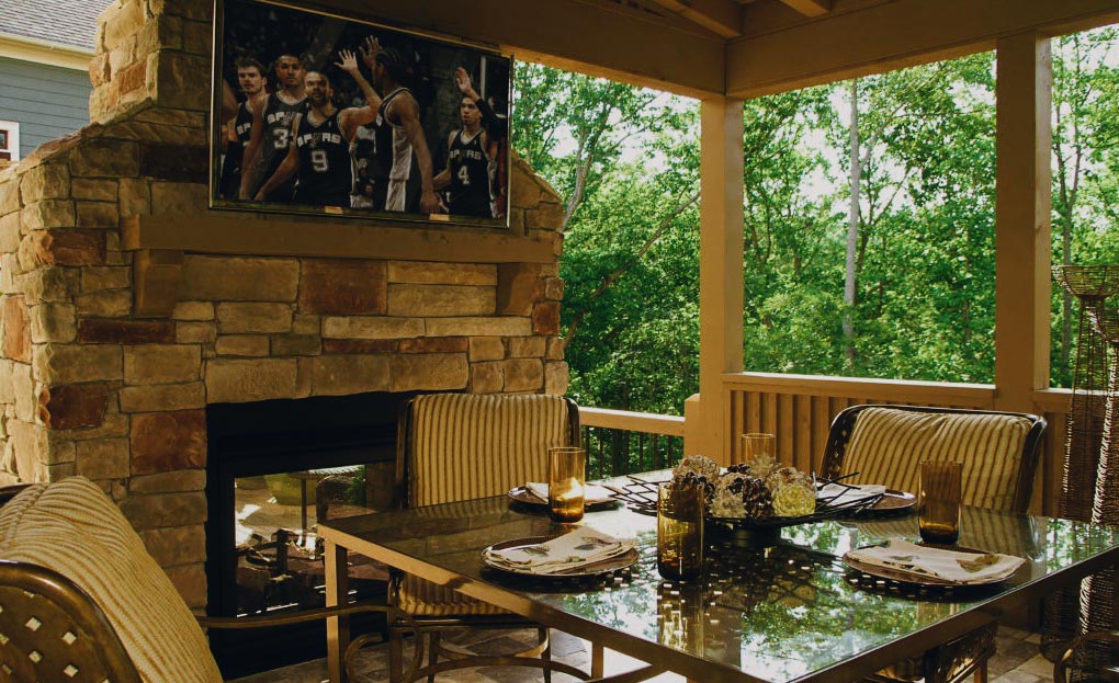 Cozy patio featuring a warm fireplace and a stylish dining table, perfect for gatherings