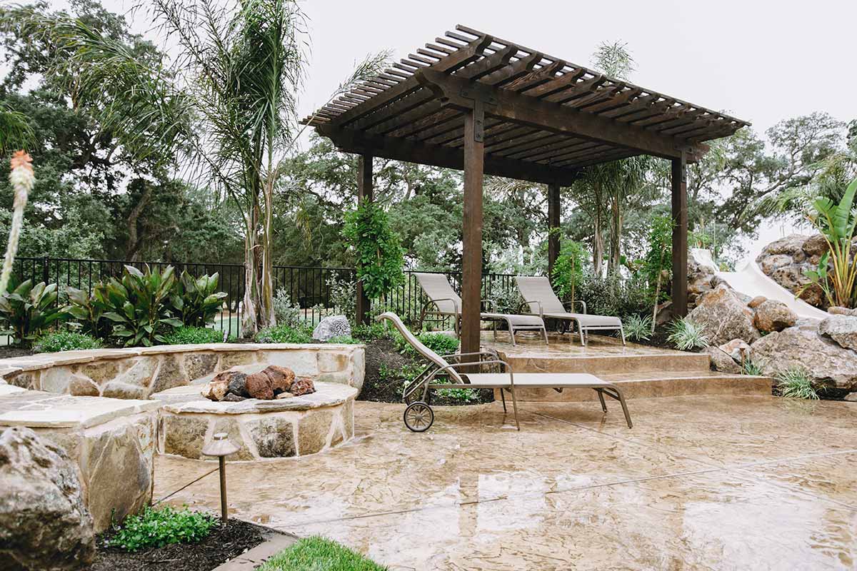 Cozy backyard featuring a fire pit and seating area, showcasing beautiful hardscapes for relaxation