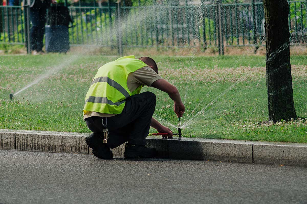 Man wearing a bright yellow vest stands confidently, showcasing his casual style and vibrant personality