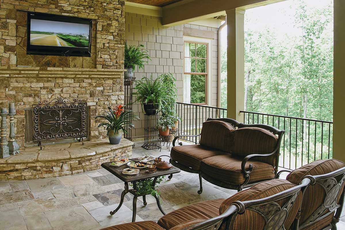 Cozy patio featuring a fireplace and a television, perfect for relaxing evenings outdoors