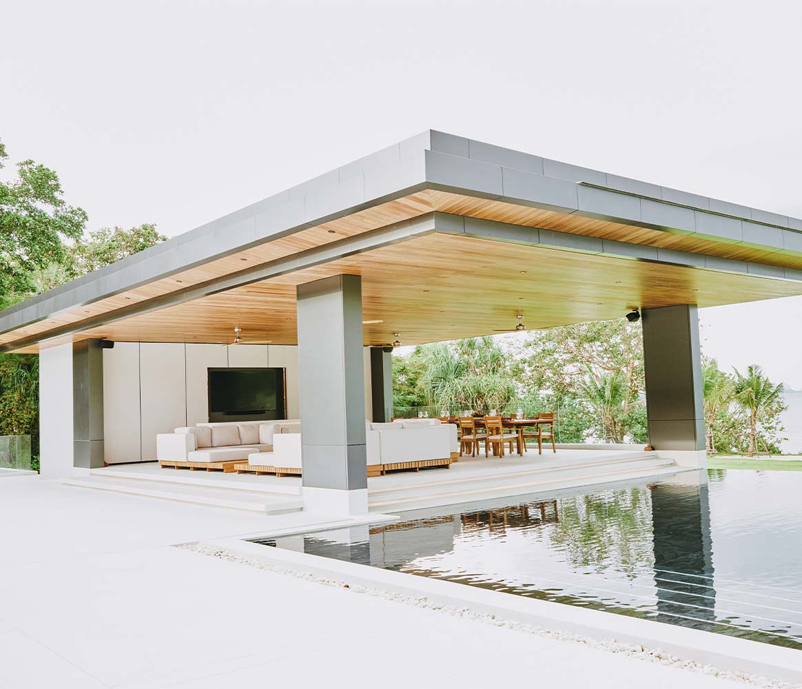 Modern home featuring a pool and outdoor living area, showcasing beautiful hardscapes for relaxation and entertainment