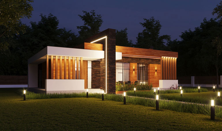 Modern house design illuminated at night, featuring bright lights adorning the lush lawn