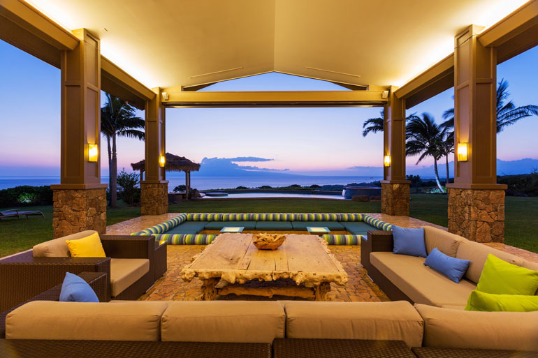 Patio with cozy couches and tables, offering a stunning view of the ocean waves Perfect for relaxation