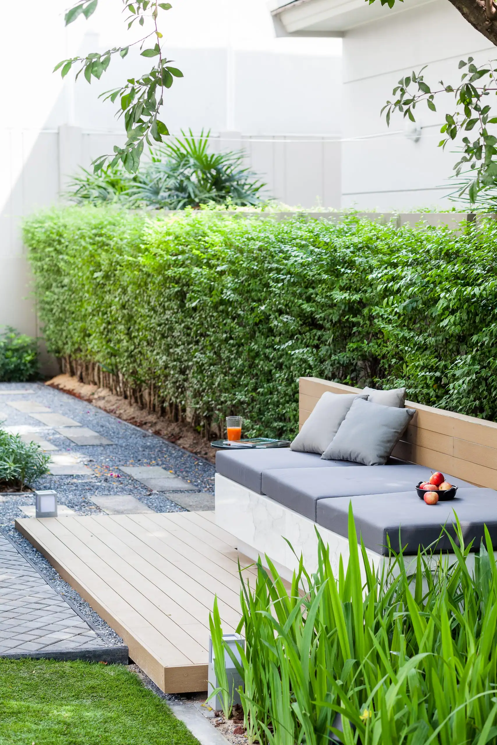 Hardscapes add structure to this tranquil outdoor space, while lush greenery provides a natural touch