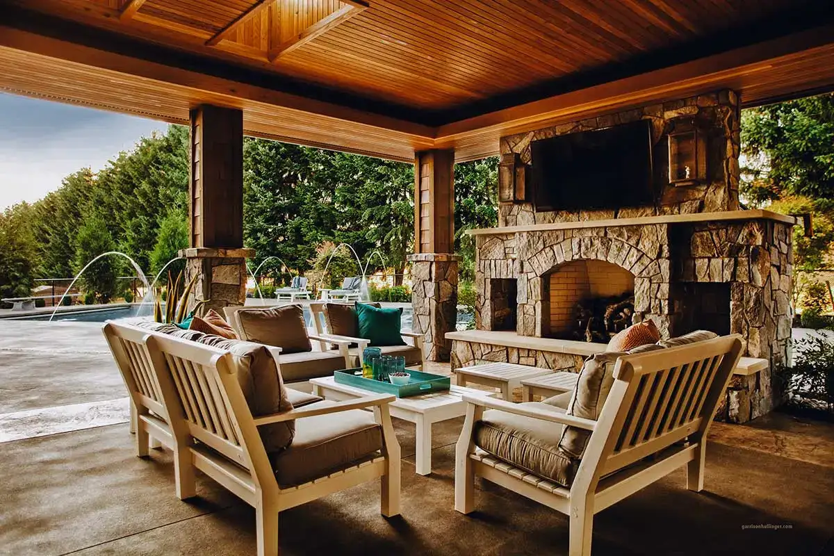 Cozy covered patio with furniture and a fireplace, showcasing beautiful Hardscapes design