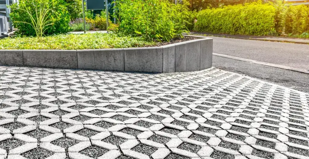 Permeable driveway with interlocking geometric pavers, combining hardscapes with sustainable landscaping