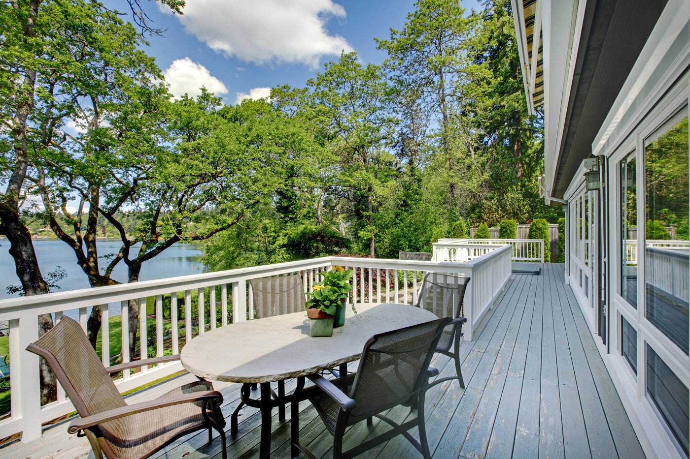Timber deck with an outdoor dining set overlooking the water in San Marcos, TX